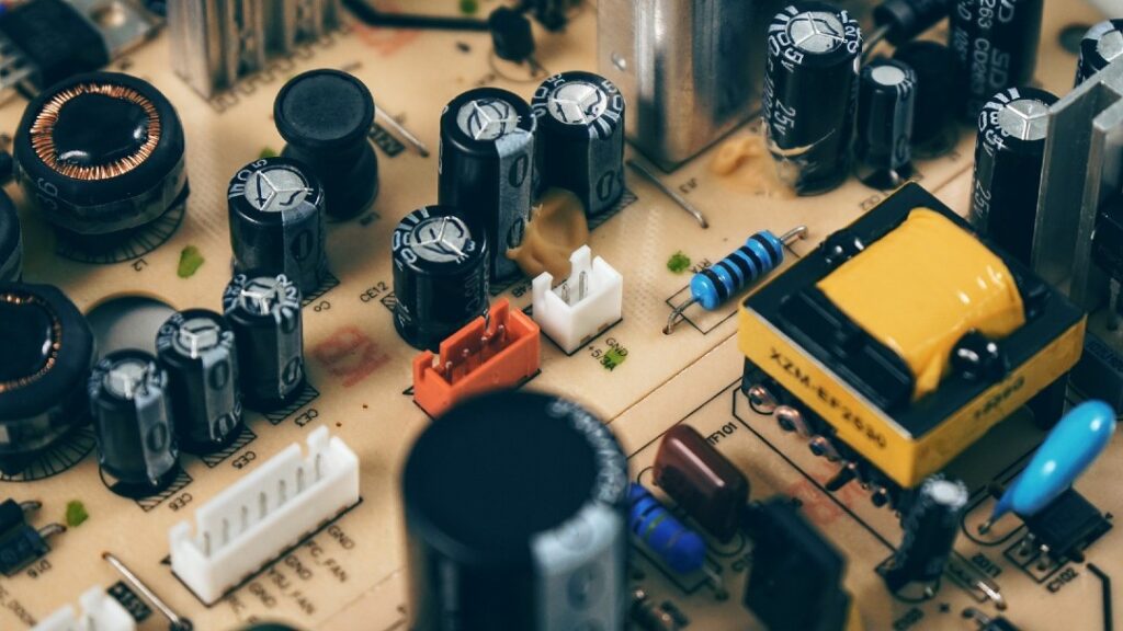 Close-up of early style circuit board with capacitors, resistors, and ICs