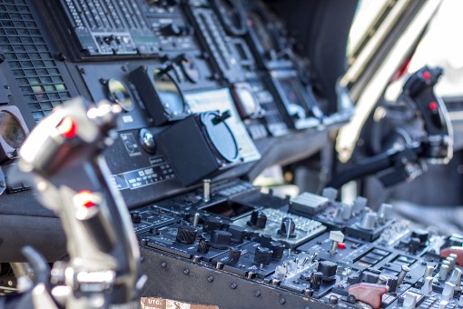 Close-up view of a jet fighter cockpit dashboard with various instruments and controls