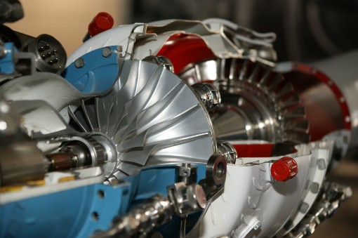 Skilled technician working on a jet engine assembly for maintenance and repair