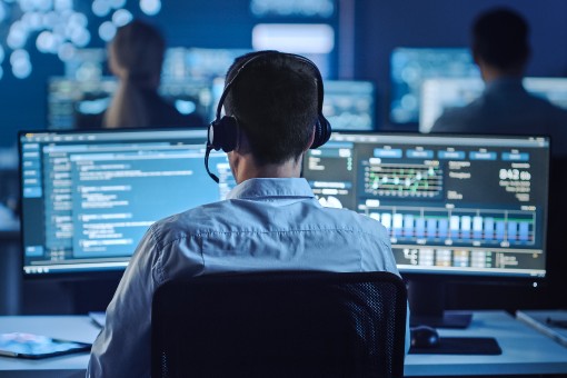 Professional technician searching an extensive database for legacy systems components